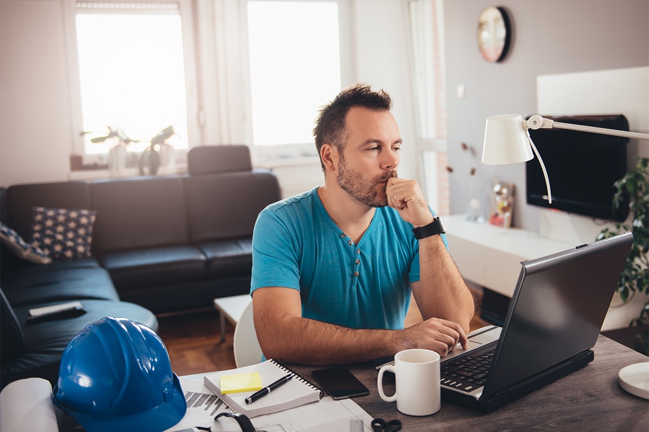 man at a computer thinking of how to safeguard his computer network