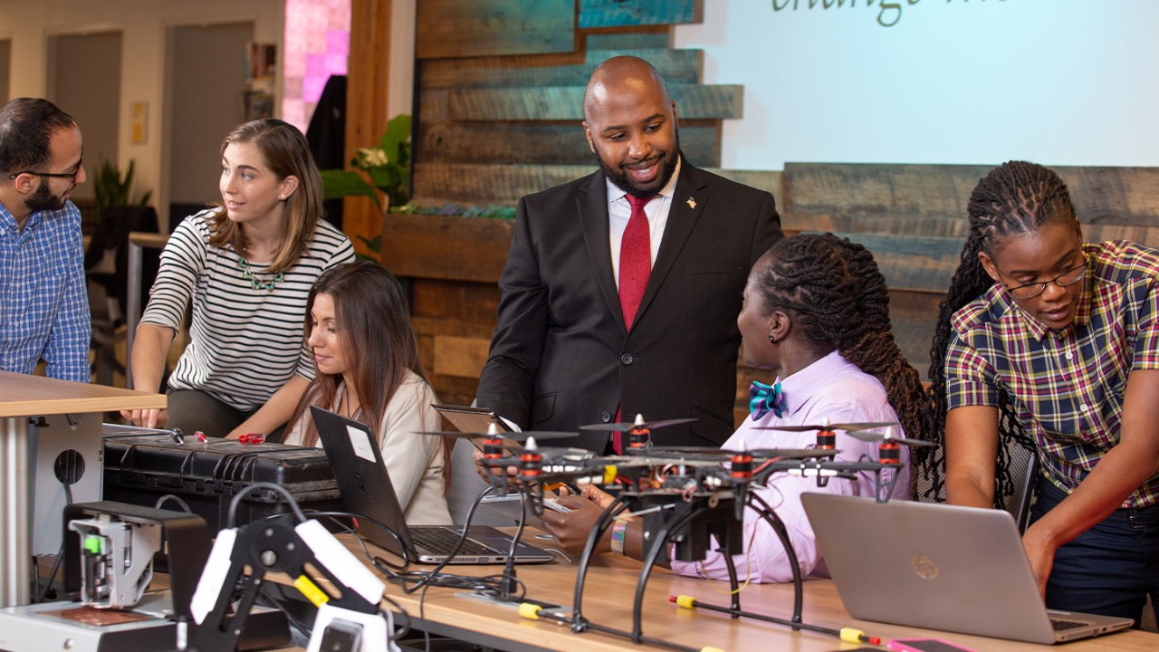 a diverse group of Booz Allen employees working on new technologies