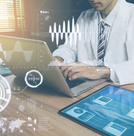 Patient data overlayed on an image of a physician sitting at desk typing on a laptop with a tablet next to him.