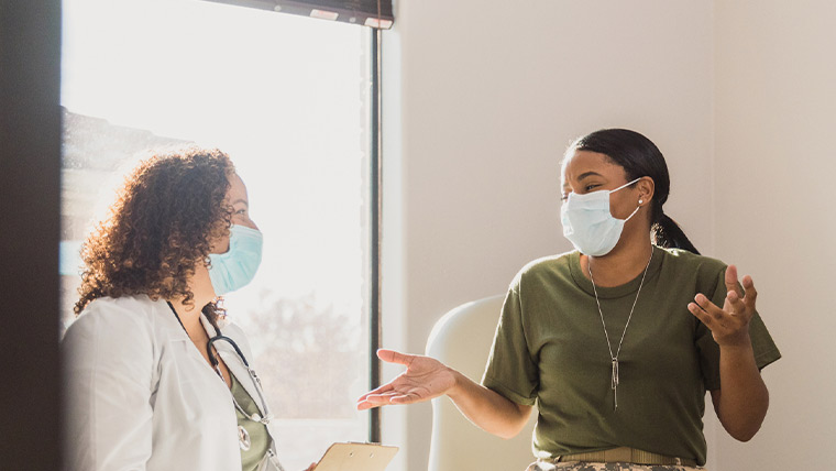 Female veteran talks with doctor