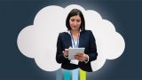 Woman holding an iPad in a networking closet.