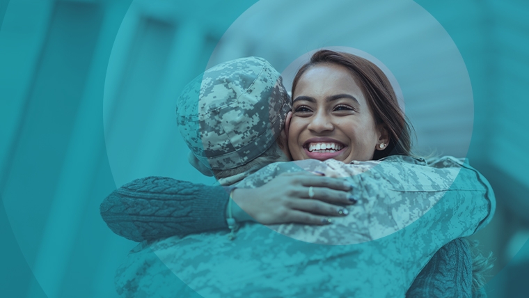 Woman hugging service member