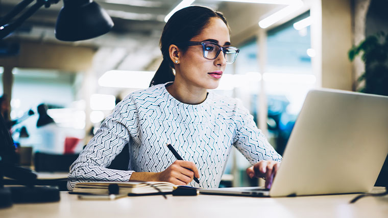 woman with glasses working