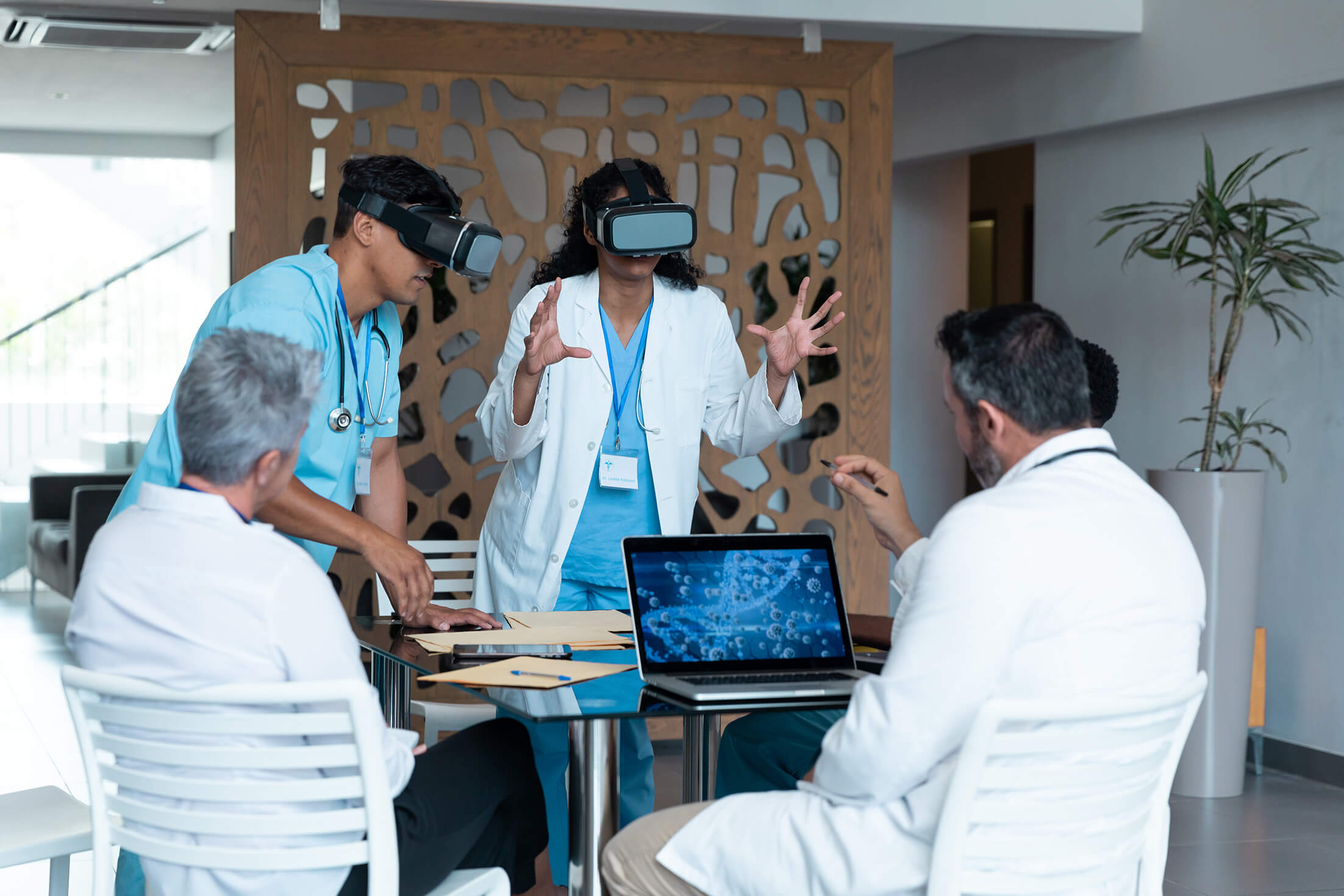 Man and woman standing with VR goggles on.